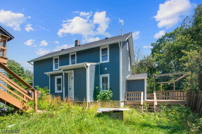 a view of a house with brick walls and a yard with plants