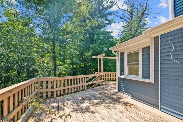 a view of balcony with wooden floor and fence
