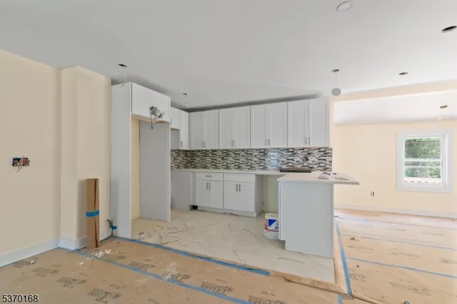 a kitchen with a refrigerator and window