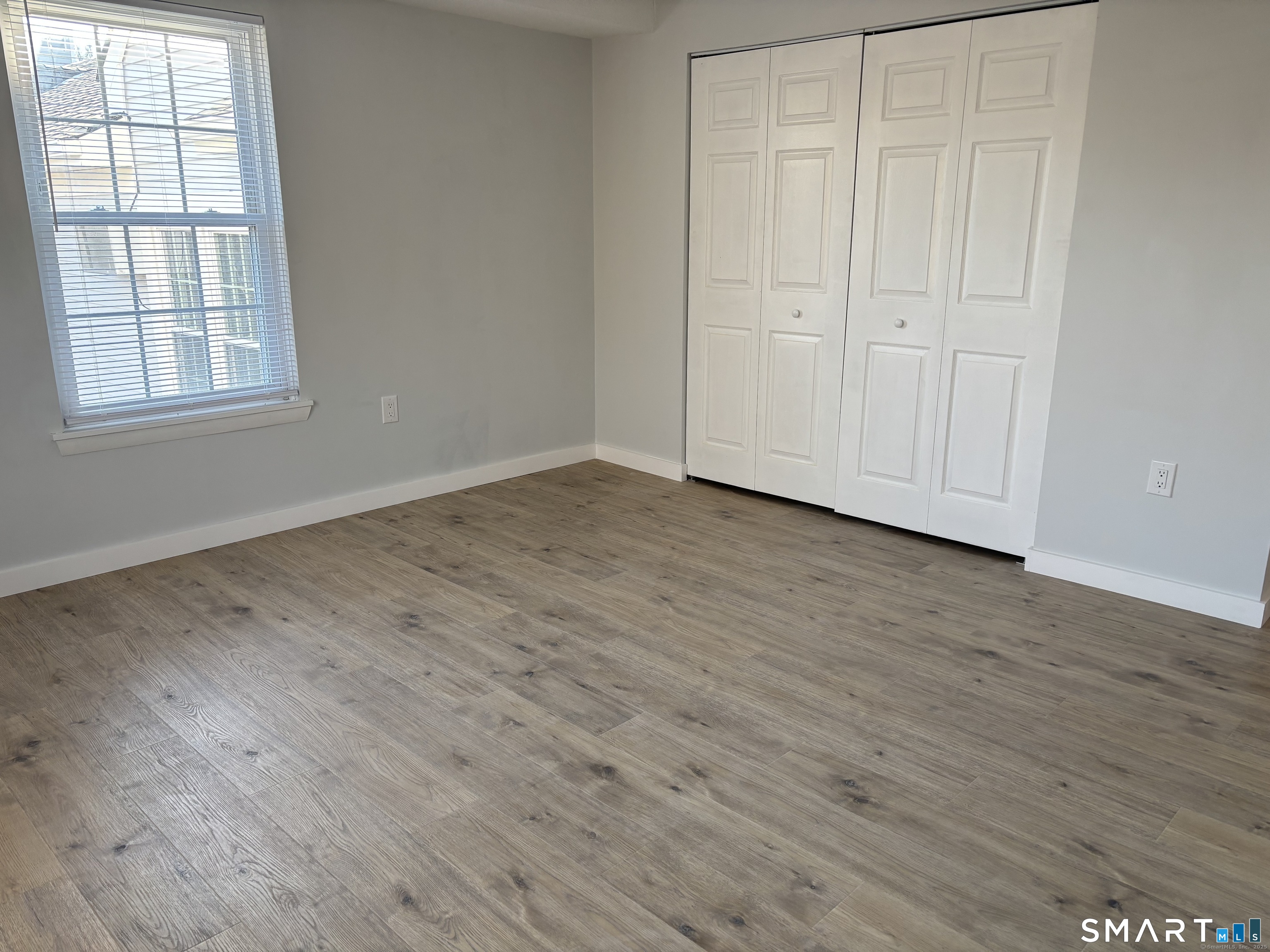 82 Longview Street, Unit 36 Waterford, CT 06385 - Photo 14 of 14 a view of an empty room with wooden floor and a window