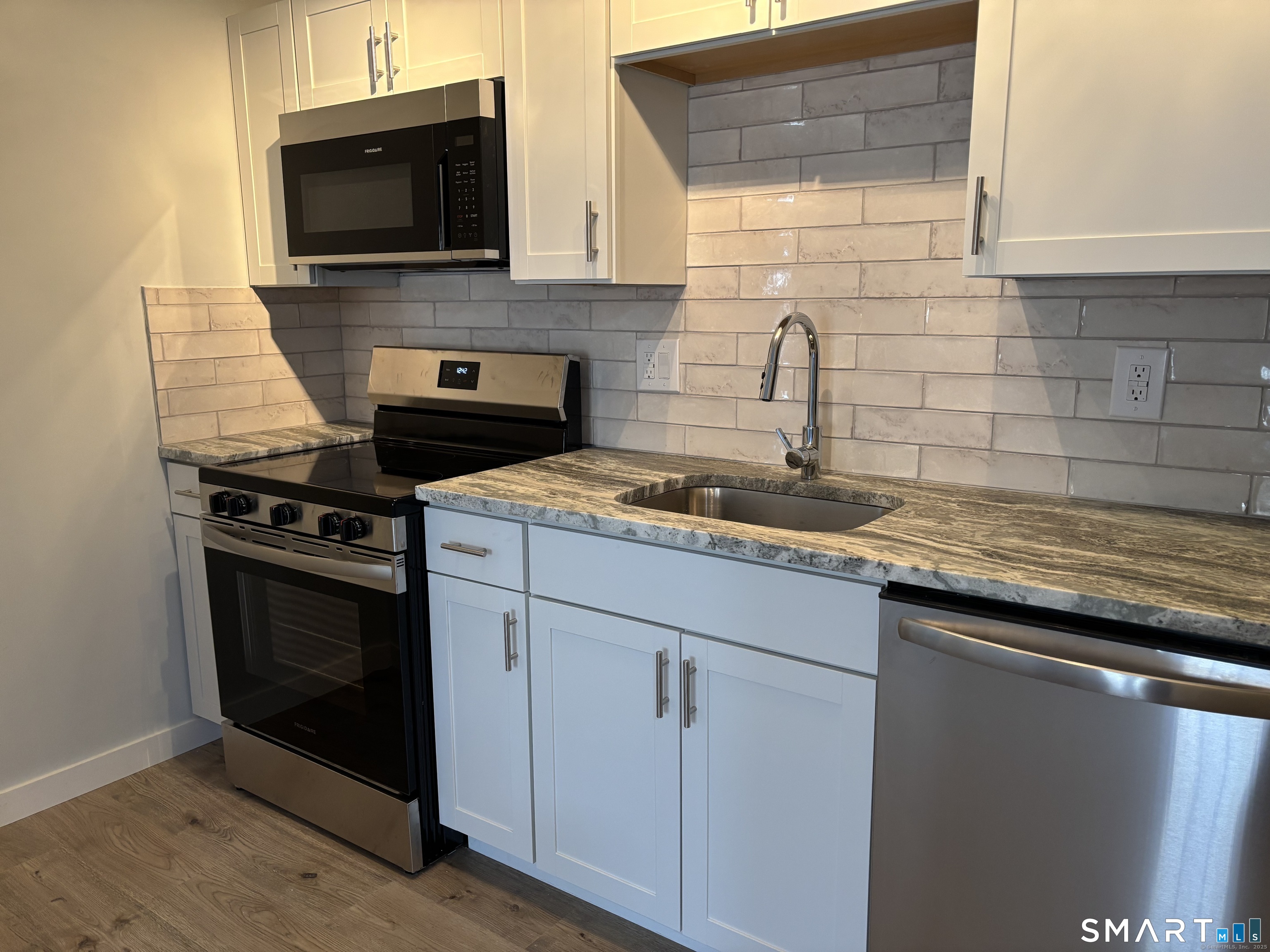 82 Longview Street, Unit 36 Waterford, CT 06385 - Photo 5 of 14 a kitchen with stainless steel appliances granite countertop a sink stove and microwave