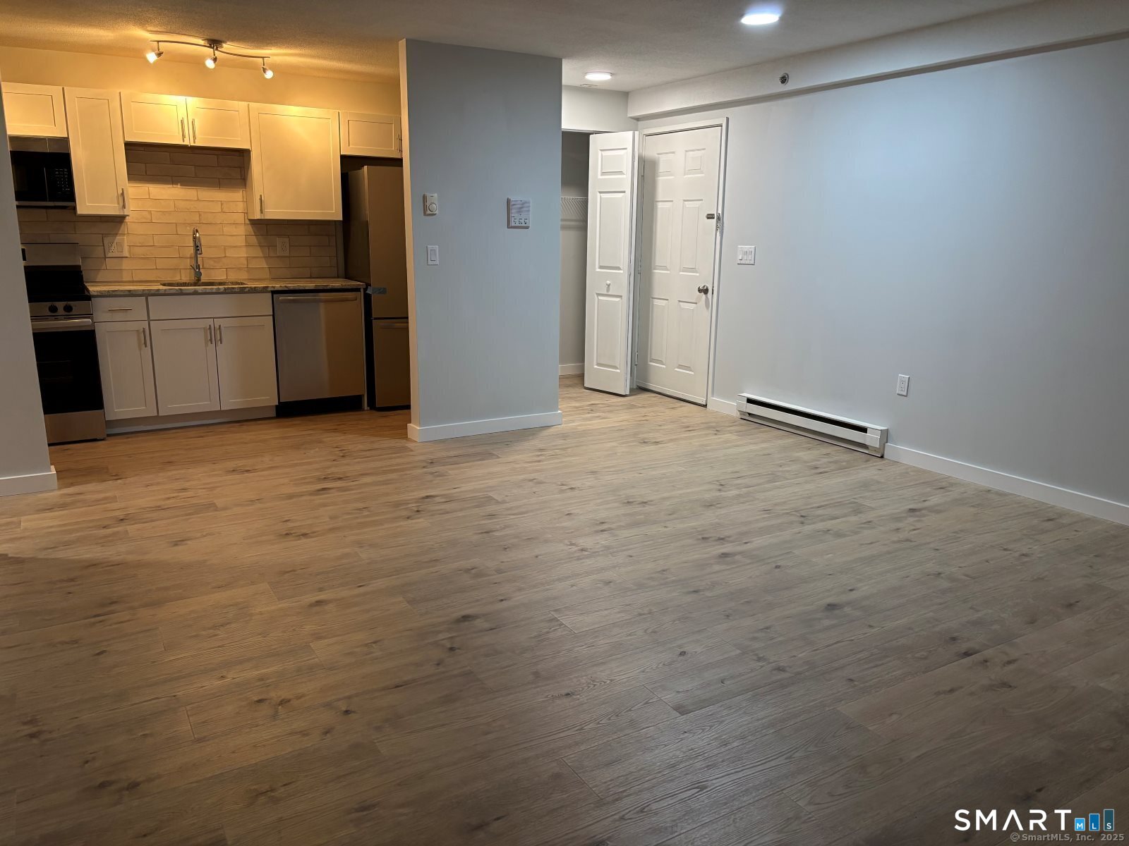 82 Longview Street, Unit 36 Waterford, CT 06385 - Photo 6 of 14 a view of an empty room with kitchen and a window