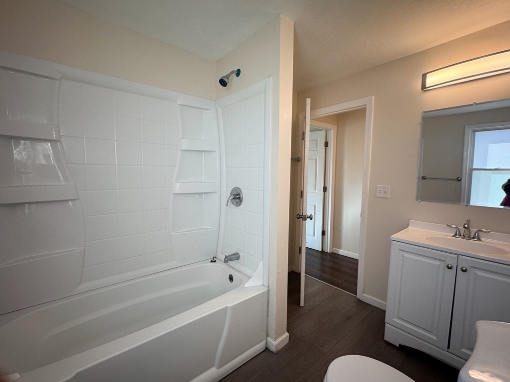 50-52 John Street Pittsfield, MA 01201 - Photo 11 of 24 a bathroom with a tub toilet sink vanity and mirror
