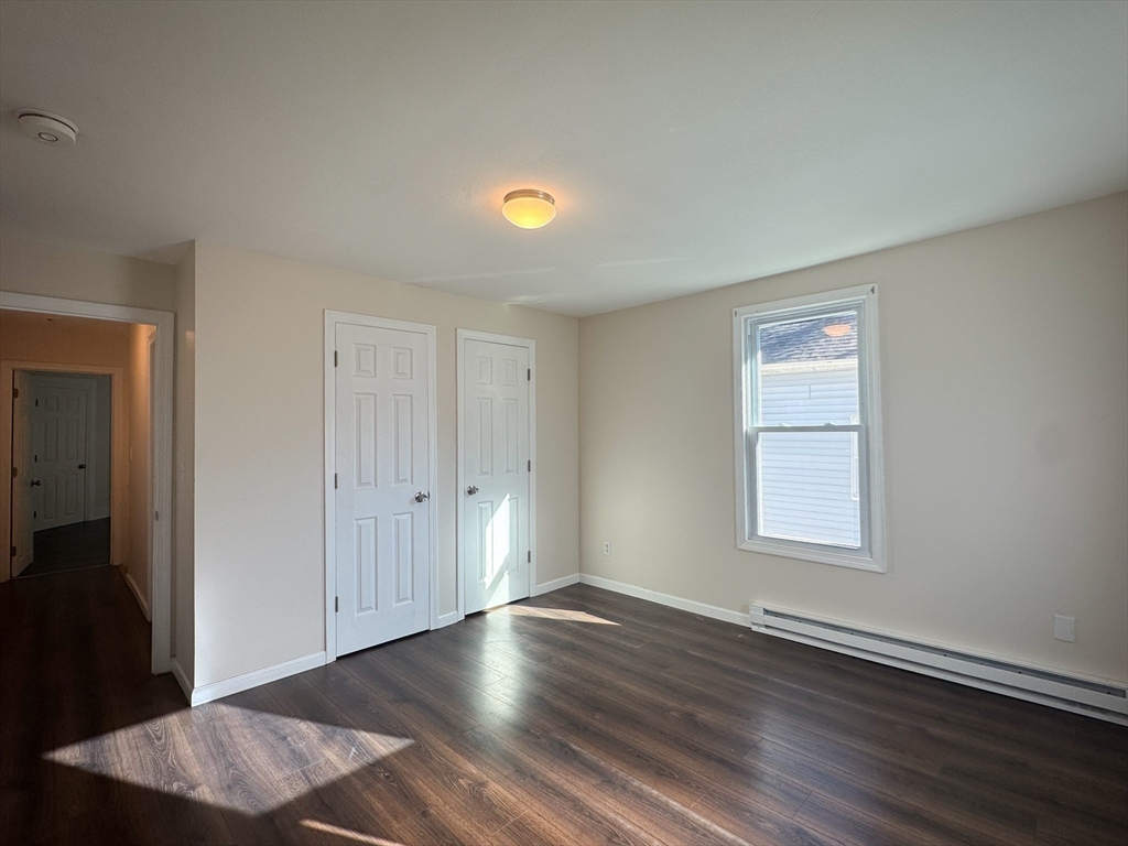 50-52 John Street Pittsfield, MA 01201 - Photo 12 of 24 an empty room with wooden floor and windows