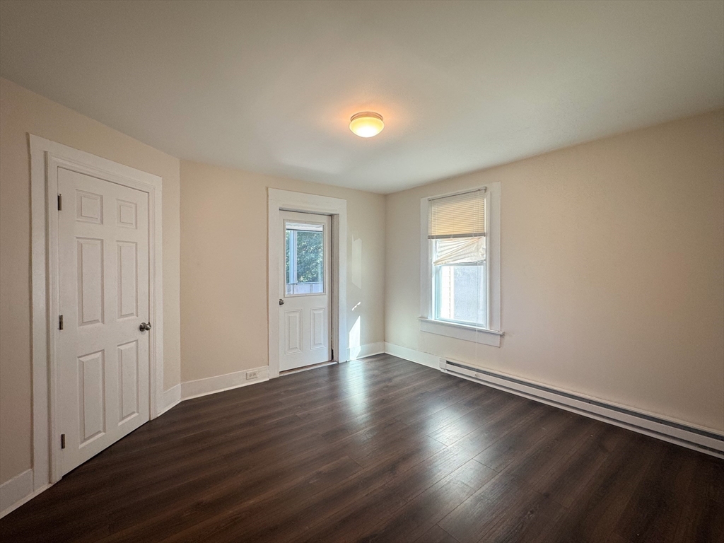 50-52 John Street Pittsfield, MA 01201 - Photo 16 of 24 an empty room with wooden floor and windows