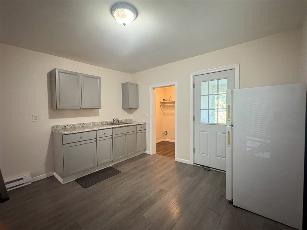 50-52 John Street Pittsfield, MA 01201 - Photo 8 of 24 a room with a sink cabinets and wooden floor