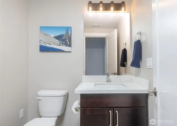 a bathroom with a sink toilet and mirror