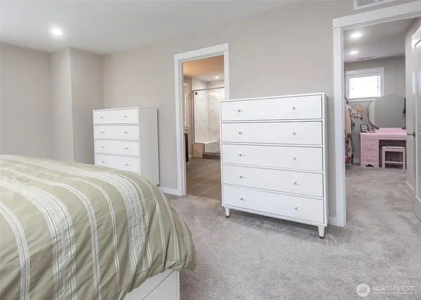 a bedroom with a bed and a dresser