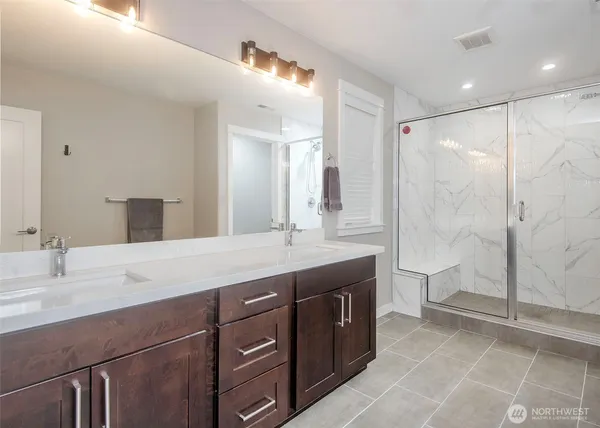 a bathroom with a granite countertop sink mirror and double