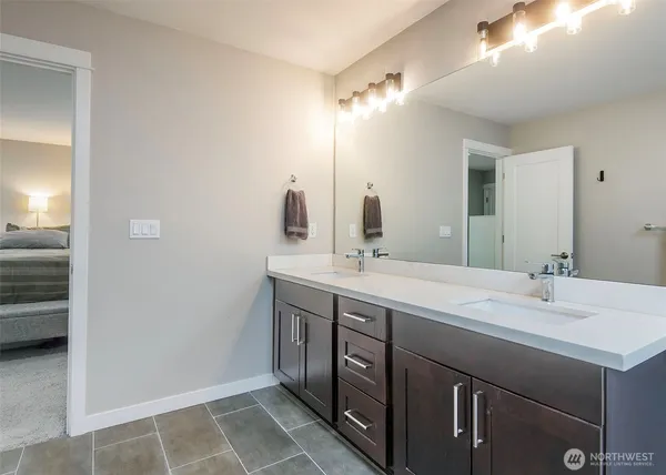 a bathroom with a double vanity sink mirror and