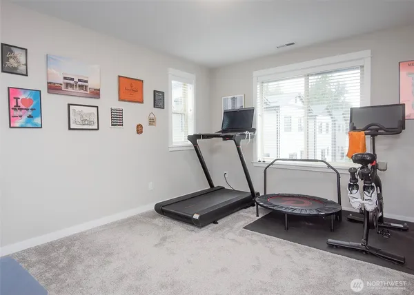 a view of a workspace with furniture and a window