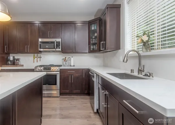 a kitchen with a sink cabinets and stainless steel appliances