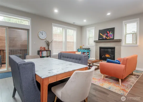 a living room with furniture a fireplace and a window