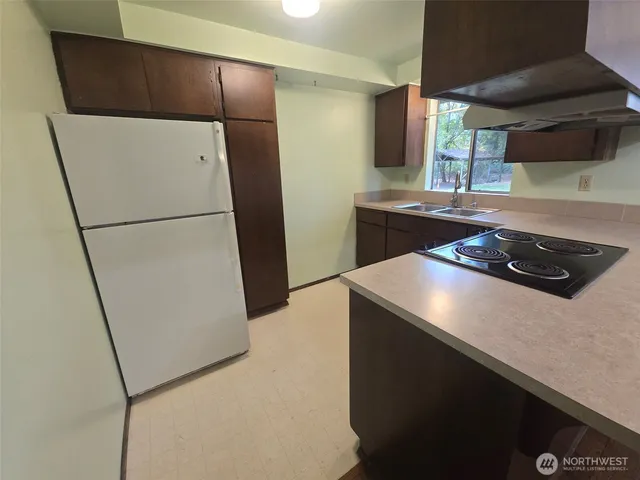 a kitchen with a refrigerator and a stove