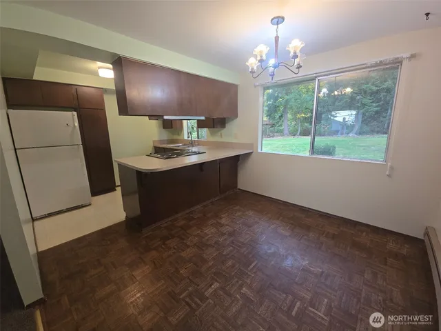 a kitchen with kitchen island a sink stainless steel appliances and cabinets
