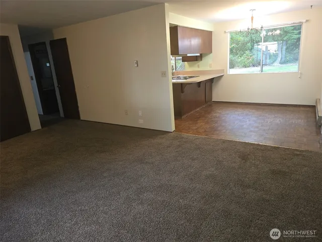 a view of a kitchen with a sink dishwasher oven window and a kitchen view
