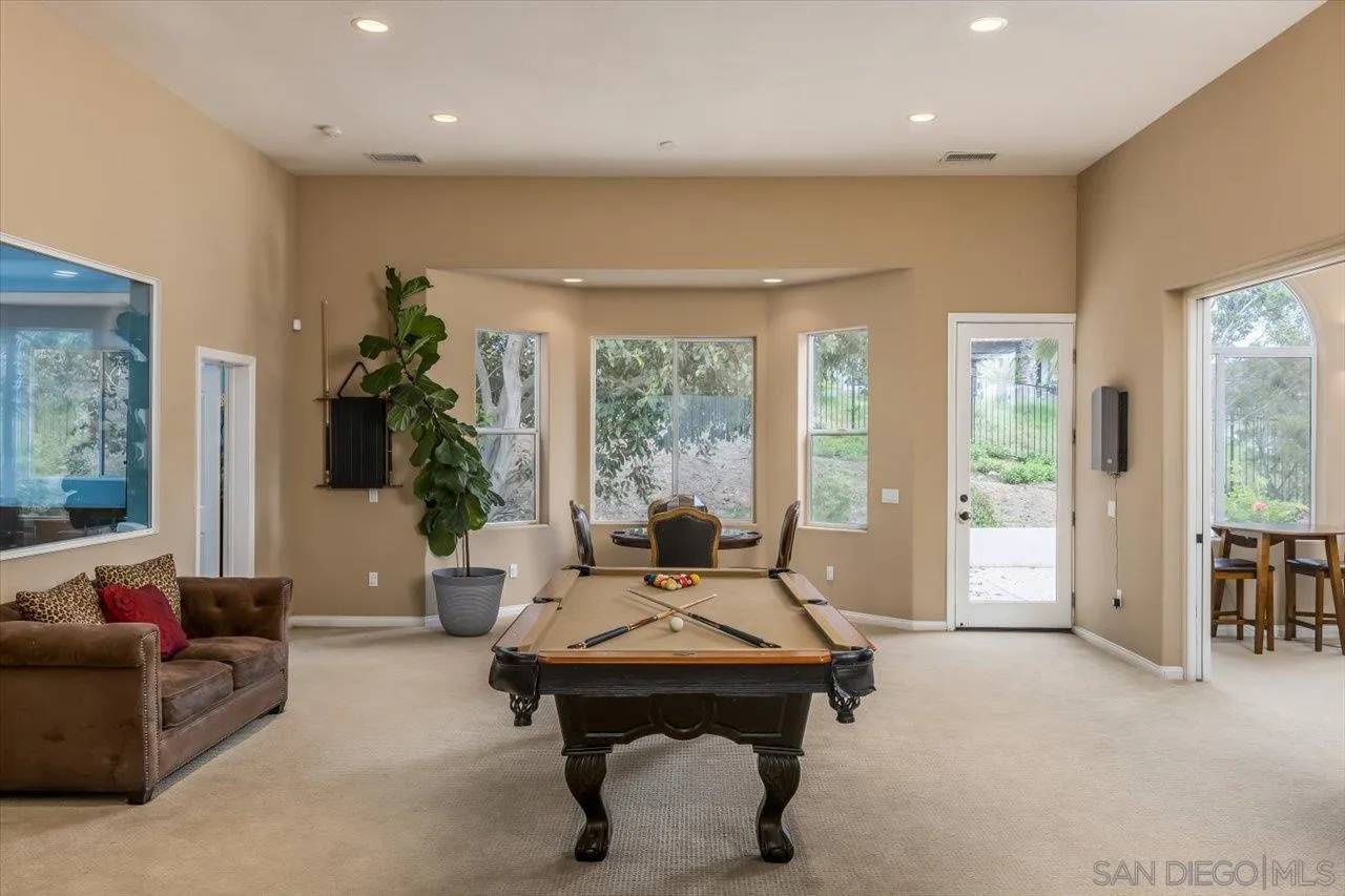 16348 Country Day Road Poway, CA 92064 - Photo 12 of 38 a living room with furniture a table and a large window
