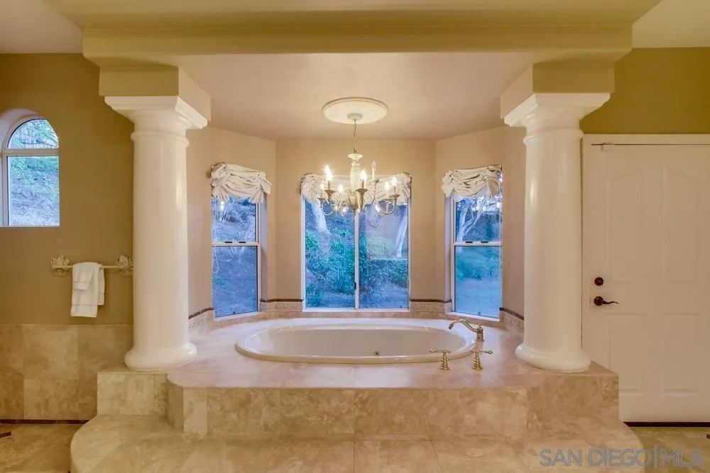 16348 Country Day Road Poway, CA 92064 - Photo 18 of 38 a view of spacious bathroom with a chandelier