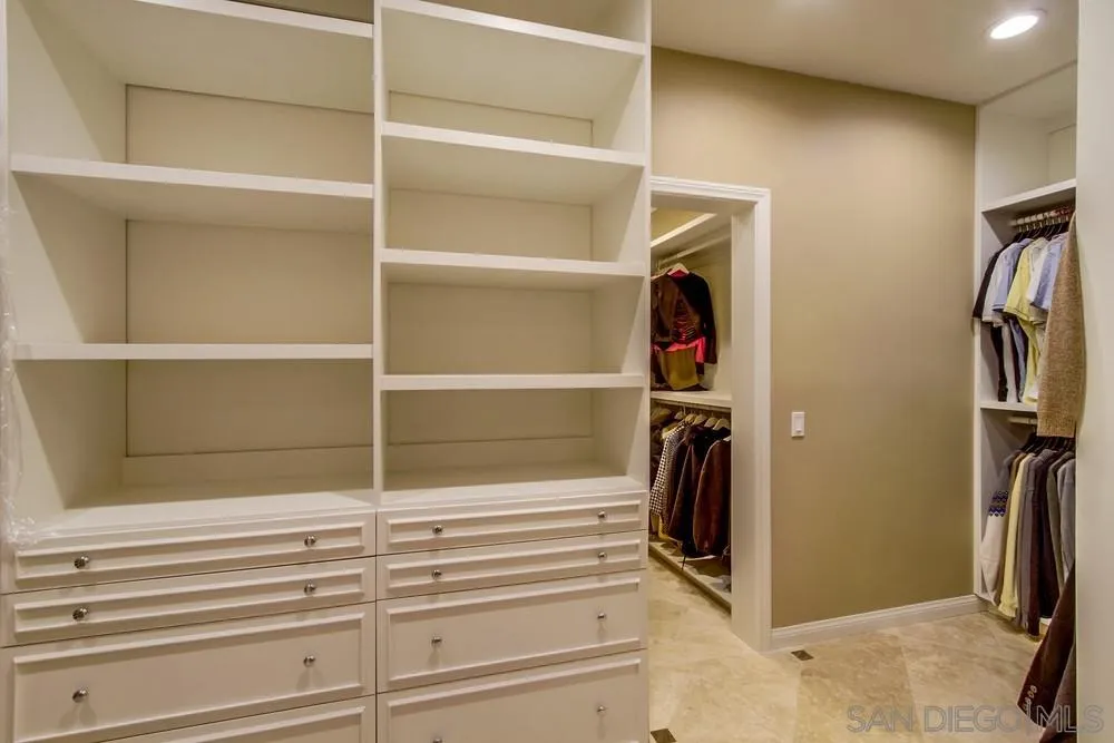 16348 Country Day Road Poway, CA 92064 - Photo 21 of 38 a view of walk in closet with clothes and shoes