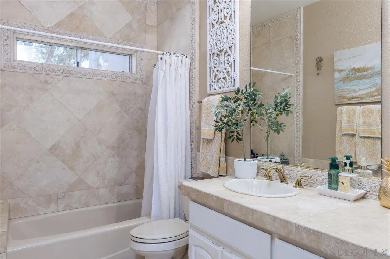 16348 Country Day Road Poway, CA 92064 - Photo 23 of 38 a bathroom with a granite countertop sink and a mirror