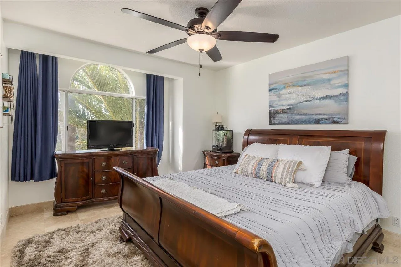 16348 Country Day Road Poway, CA 92064 - Photo 26 of 38 a bedroom with a large bed and a chandelier
