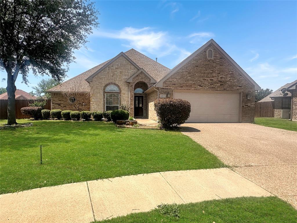 10717 Greenview Court Benbrook, TX 76126 - Photo 1 of 36 a front view of a house with a garden and yard