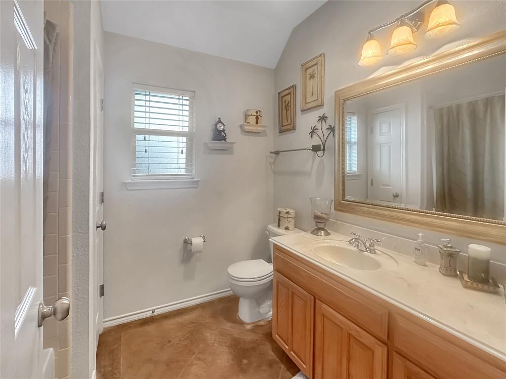 10717 Greenview Court Benbrook, TX 76126 - Photo 14 of 36 a bathroom with a sink a toilet and a mirror