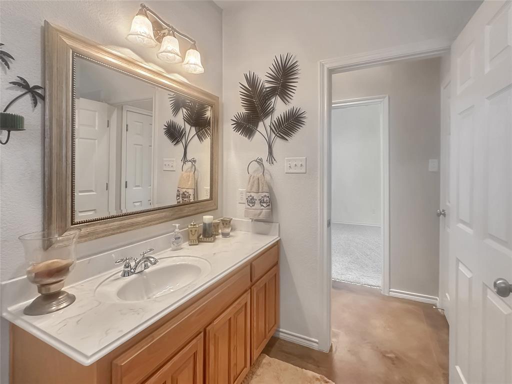 10717 Greenview Court Benbrook, TX 76126 - Photo 16 of 36 a bathroom with a sink vanity and a mirror
