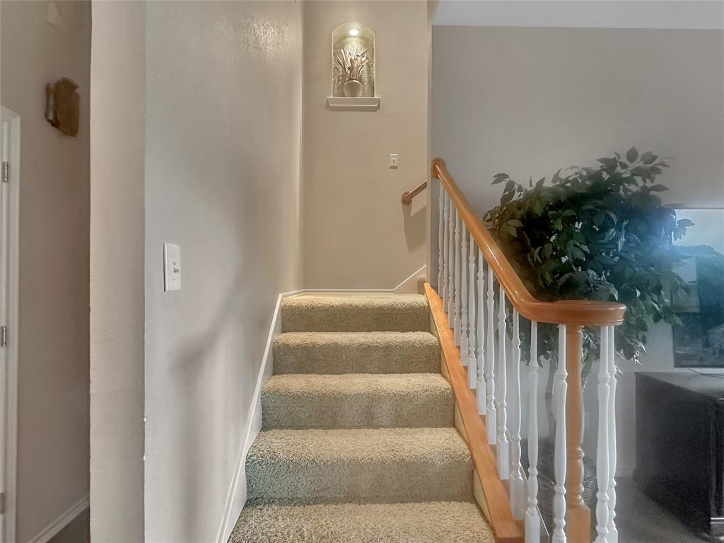 10717 Greenview Court Benbrook, TX 76126 - Photo 18 of 36 a view of staircase with lots of frames on wall