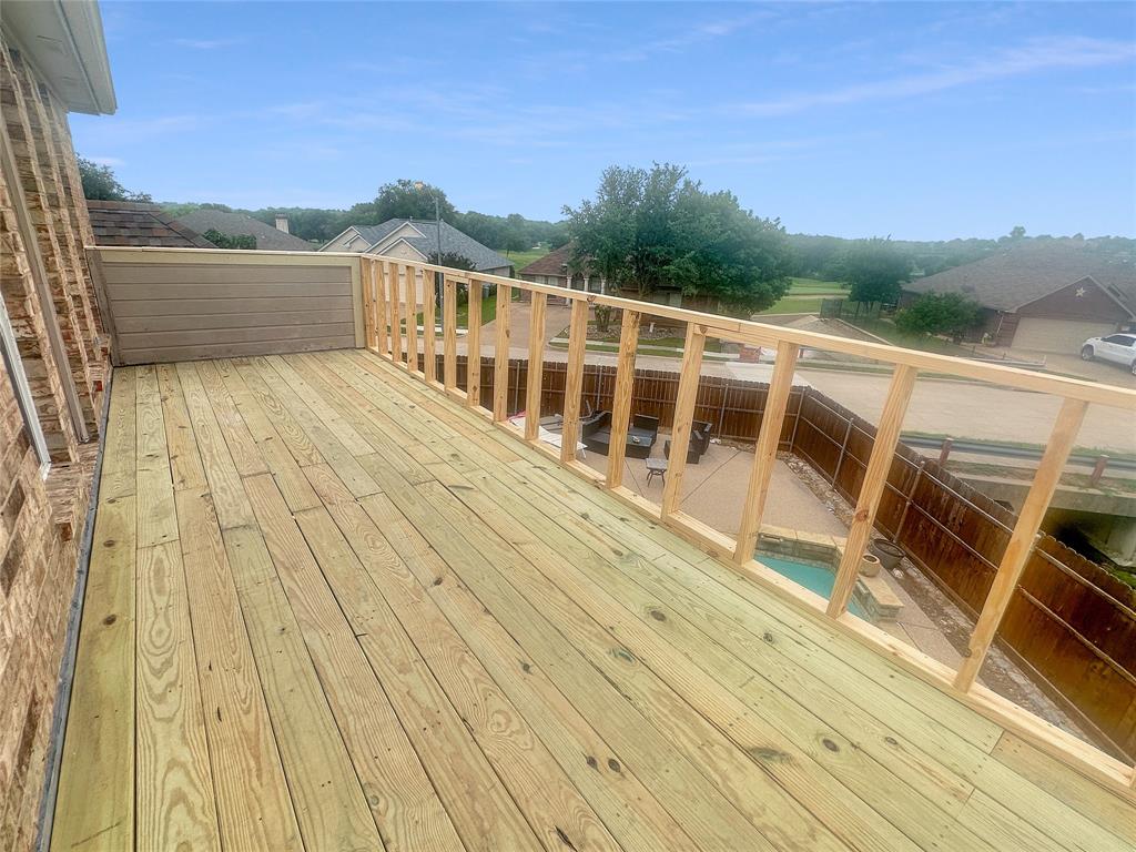 10717 Greenview Court Benbrook, TX 76126 - Photo 23 of 36 a view of a balcony with wooden floor and city view