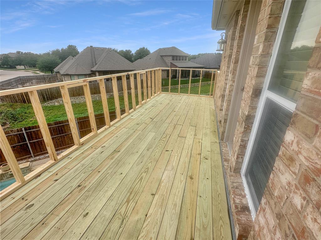 10717 Greenview Court Benbrook, TX 76126 - Photo 24 of 36 a view of wooden balcony with a ocean view