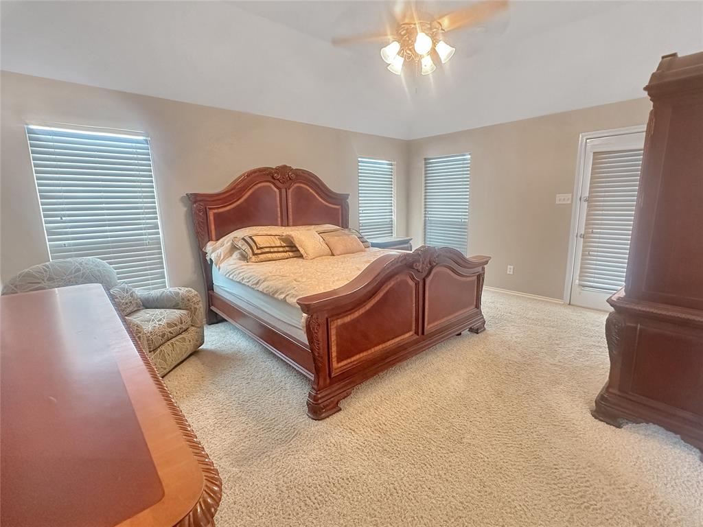10717 Greenview Court Benbrook, TX 76126 - Photo 7 of 36 a bedroom with a bed lamp and a window