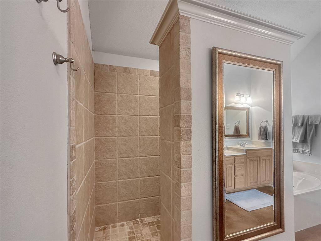 10717 Greenview Court Benbrook, TX 76126 - Photo 9 of 36 a bathroom with a glass shower door