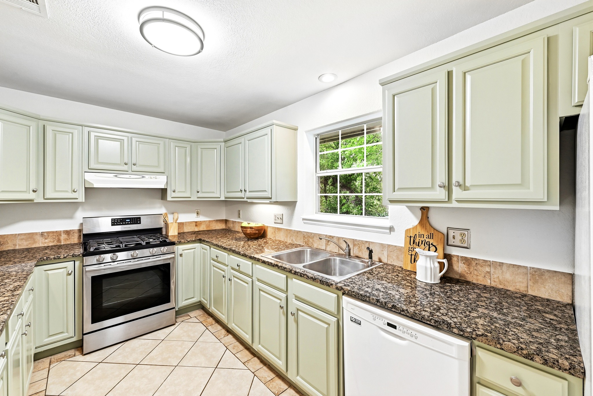2405 Bahama Road Austin, TX 78733 - Photo 16 of 39 The kitchen features painted cabinetry and granite counters.