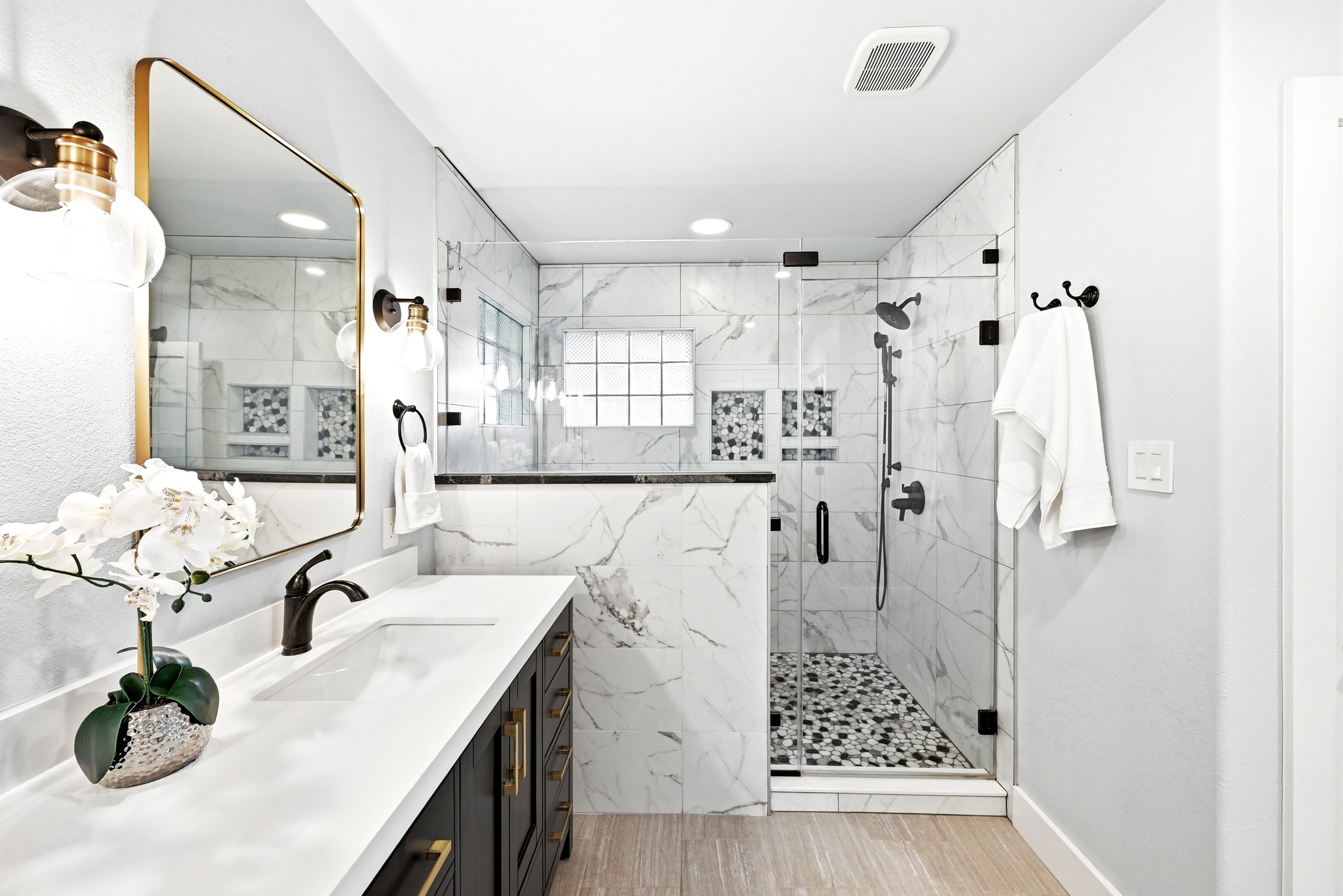 2405 Bahama Road Austin, TX 78733 - Photo 25 of 39 The expansive walk-in shower features stylish and practical soap niches along with dual showerheads.