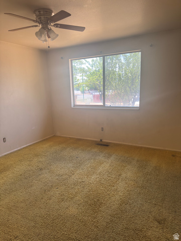 992 300 East Orem, UT 84057 - Photo 5 of 7 Bedroom with textured carpeting and a ceiling fan light fixture