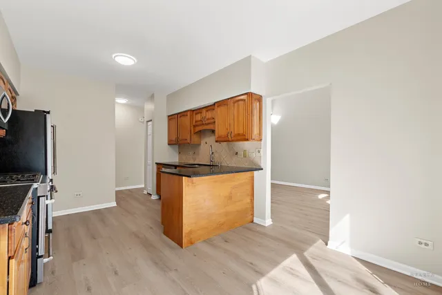a view of kitchen and wooden floor