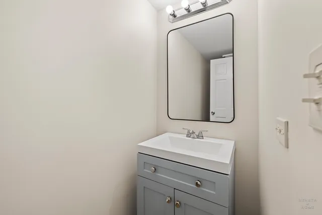 a bathroom with a sink vanity and a mirror