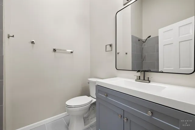 a bathroom with a sink a toilet and mirror