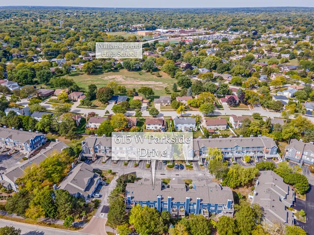 an aerial view of residential houses with outdoor space