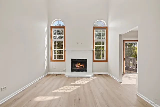 a view of a livingroom with a fireplace and window