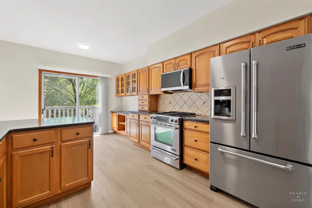 a kitchen with stainless steel appliances a refrigerator sink and cabinets