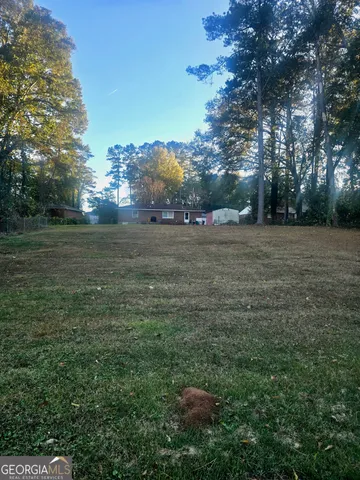 a view of a field of grass and trees