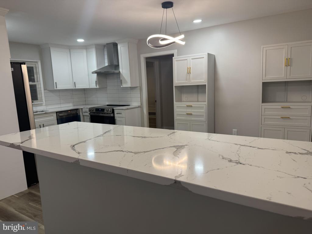 24 Pilgrim Lane Willingboro, NJ 08046 - Photo 22 of 31 a kitchen with kitchen island a sink stainless steel appliances and cabinets
