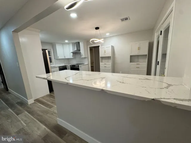a large bathroom with a large mirror vanity and a sink