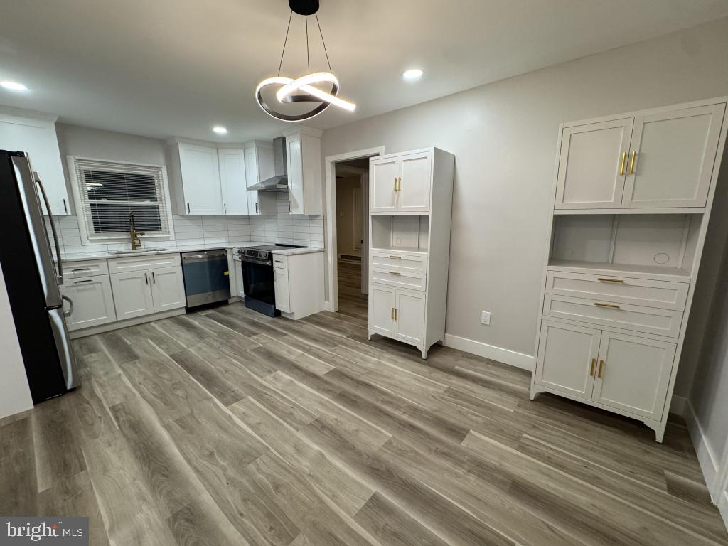 24 Pilgrim Lane Willingboro, NJ 08046 - Photo 24 of 31 a large kitchen with stainless steel appliances granite countertop a stove a sink and a refrigerator