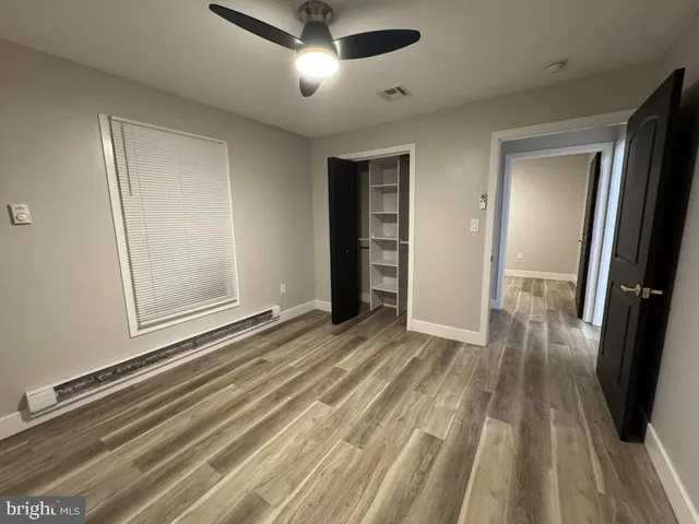 a view of a room with wooden floor and staircase