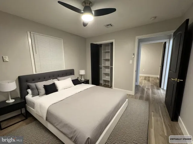 a bedroom with a bed and a large mirror