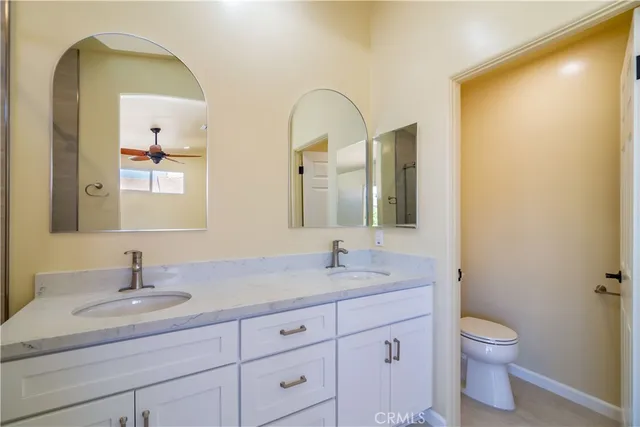 a bathroom with a double vanity sink mirror and shower