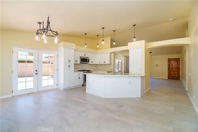 a large kitchen with stainless steel appliances granite countertop a stove a sink dishwasher and a refrigerator